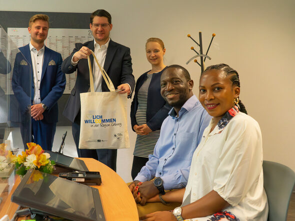 OB Dominik Sauerteig übergibt symbolisch die erste Neubürgertasche an Achombili Asango und Findo Floreen Linwe.