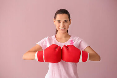 Beautiful,Woman,With,Pink,Ribbon,And,Boxing,Gloves,On,Color